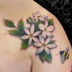 Realistic Jasmine with honeybee tattoo on shoulder