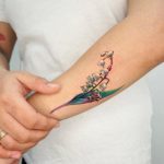 Realistic Lily of the valley and frog tattoo