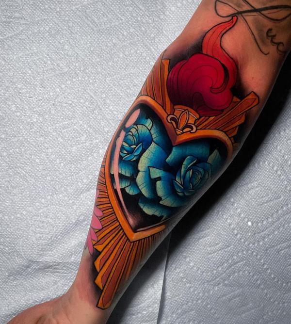 Sacred heart half sleeve tattoo with blue rose and halo