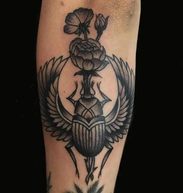Scarab Beetle pushing flower tattoo