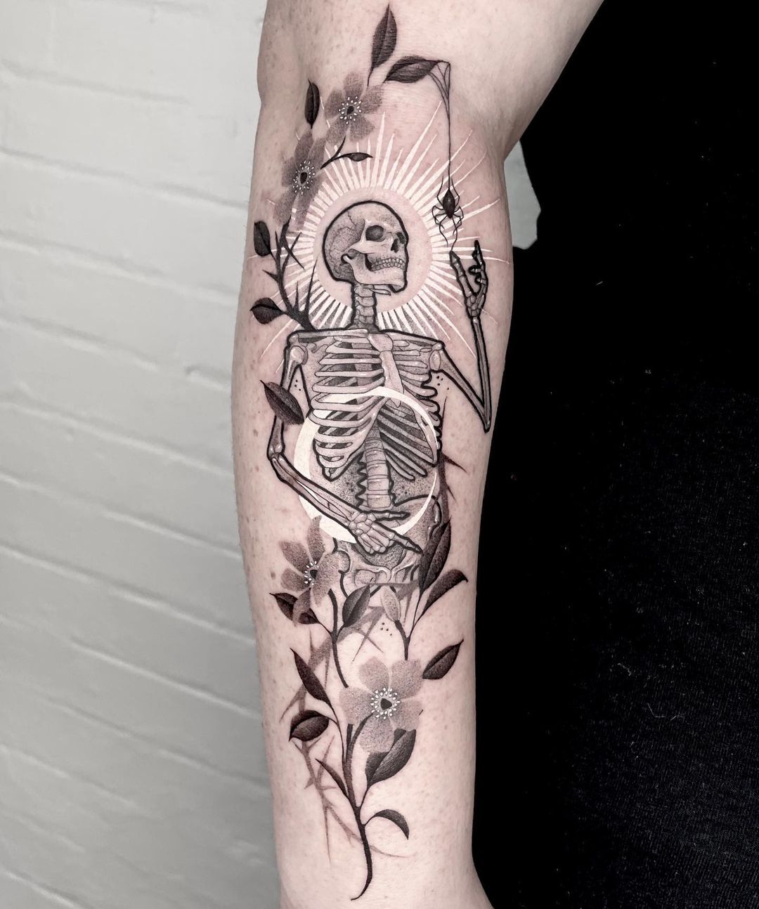 Skeleton with halo arm tattoo