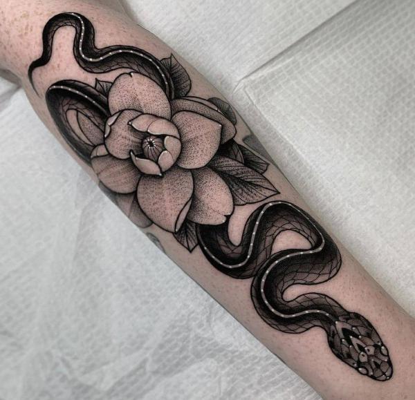 Snake and flower dotwork forearm tattoo
