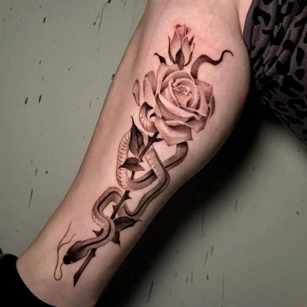 Snake and rose forearm tattoo