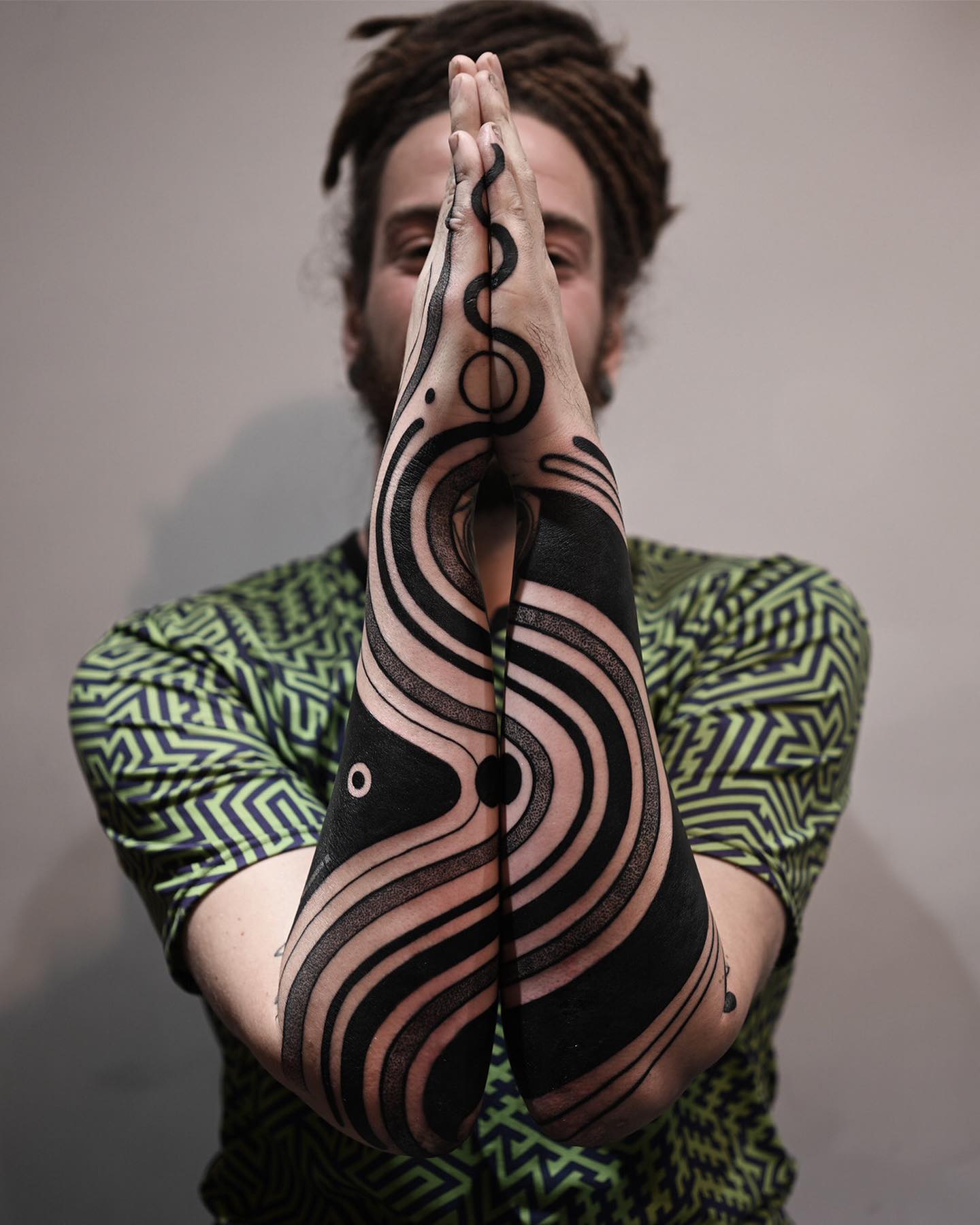 Swirling lines matching forearm tattoos