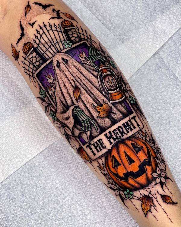 The Hermit tarot card and carved pumpkin