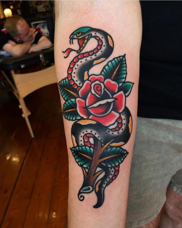 Traditional rose and snake forearm tattoo