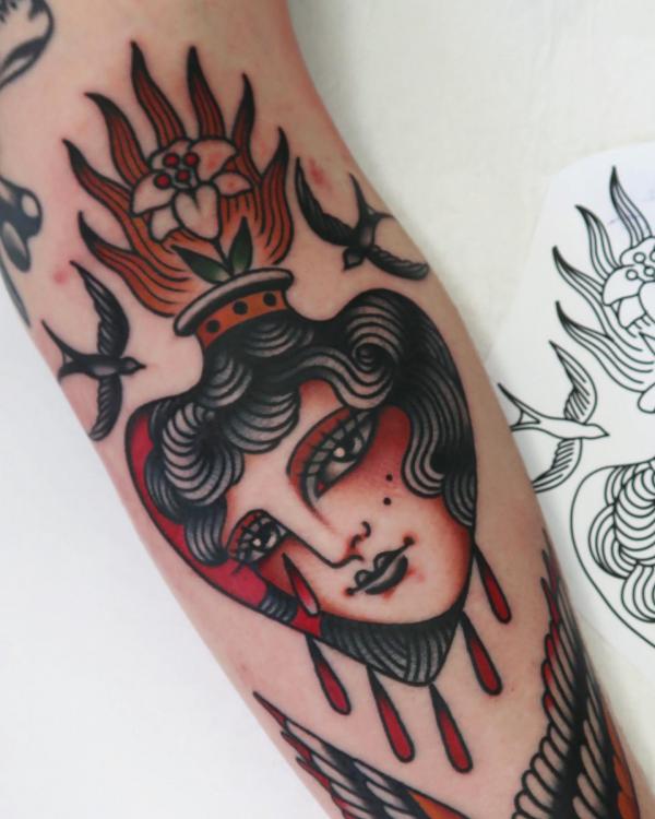 Traditional sacred heart tattoo with sparrows and womans face