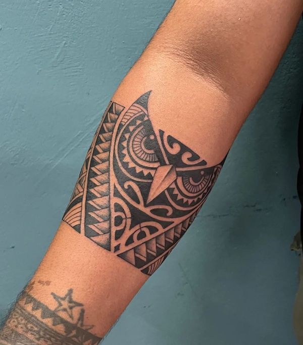 tribal owl arm tattoos