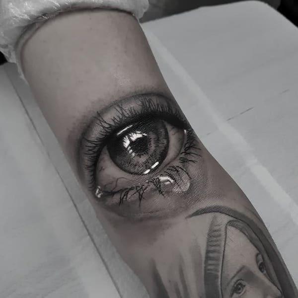 Virgin Mary and eye tattoo
