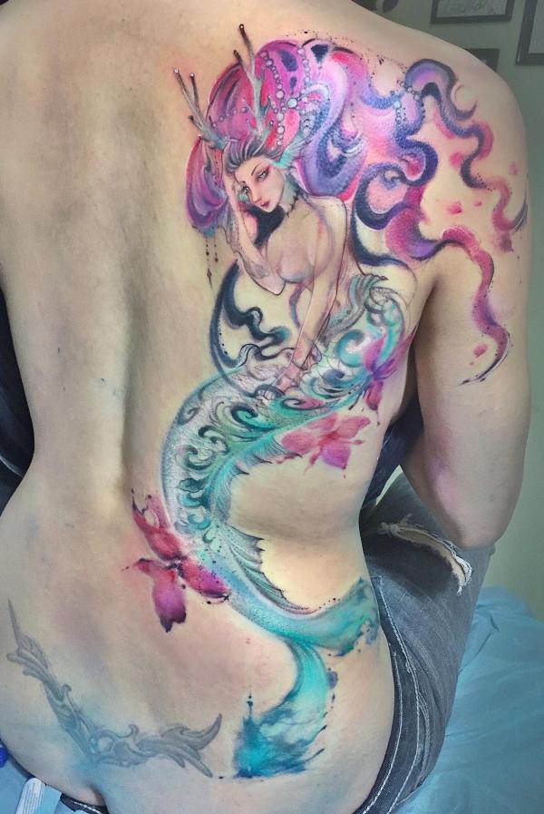 Watercolor mermaids tattoo on one side of back