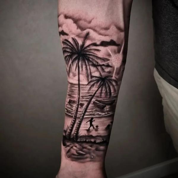 A boy playing football at beach under palm tree