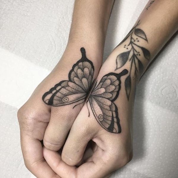 A butterfly dotwork on both hands