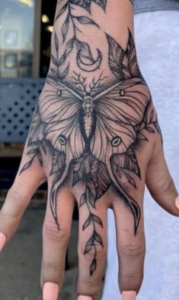 A butterfly on leaves under moon