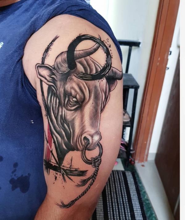 A realistic bull head hal sleeve tattoo