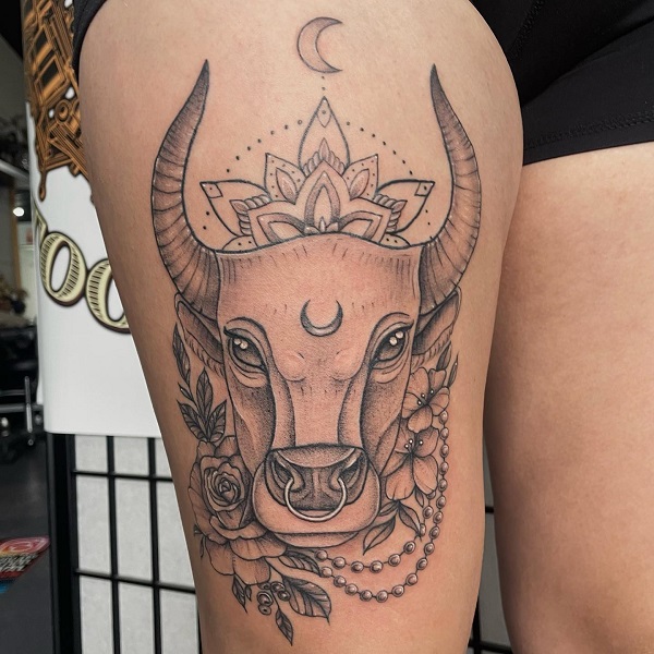 Bull head surrounded with mandala flowers and pearls