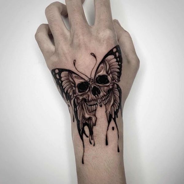 Buterfly skull hand tattoo