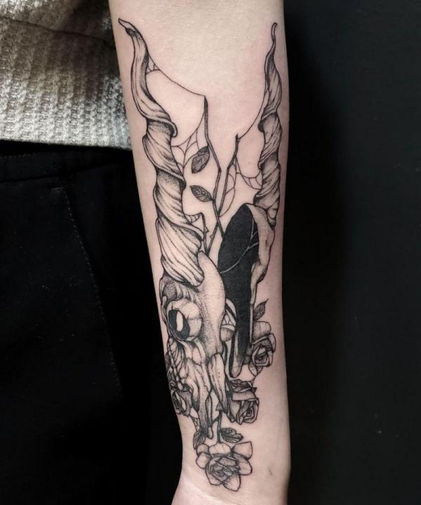 Cracked goat skull with spider webs and flowers