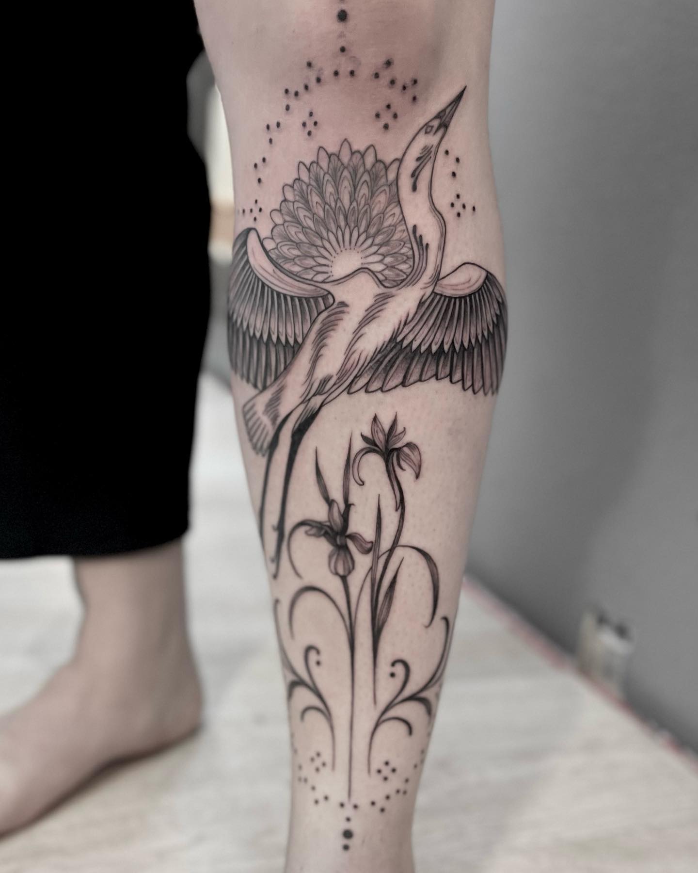 Crane tattoo with iris and lotus flowers