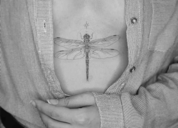 Delicate dragonfly sternum tattoo