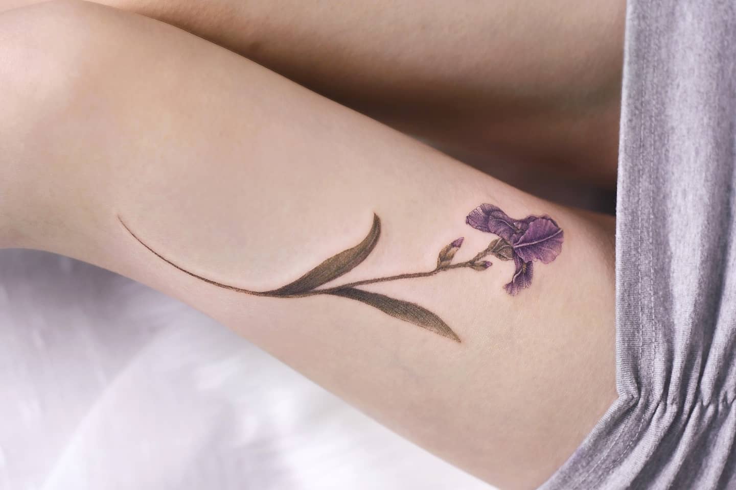 Elegant iris thigh tattoo