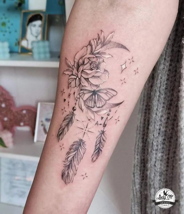 Floral crescent moon and stars adorned with feathers
