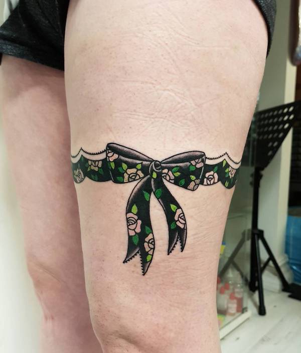 Flower ribbon garter tattoo