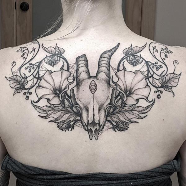 Gorgeous floral goat skull upper back tattoo