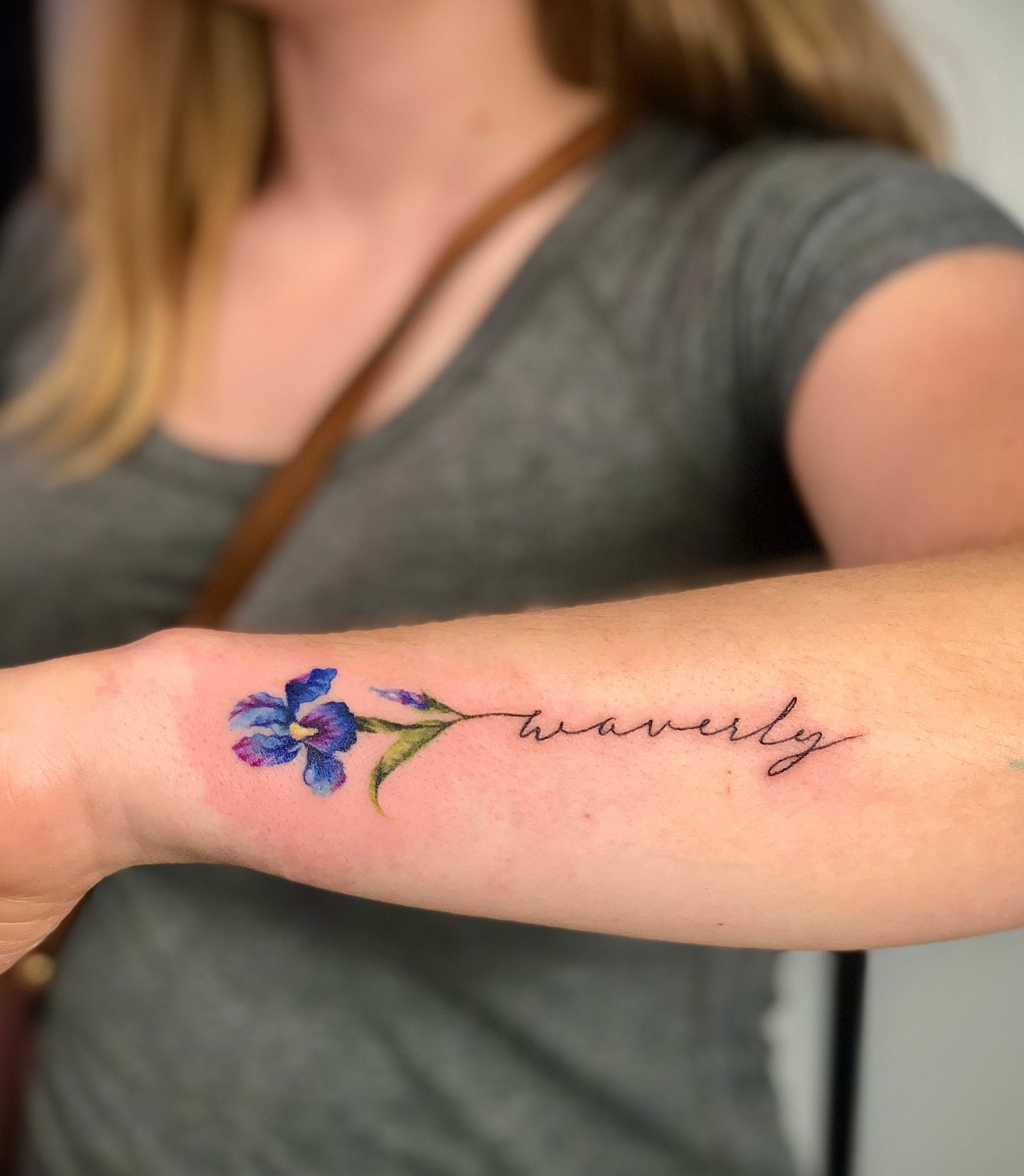 Iris forearm tattoo with lettering