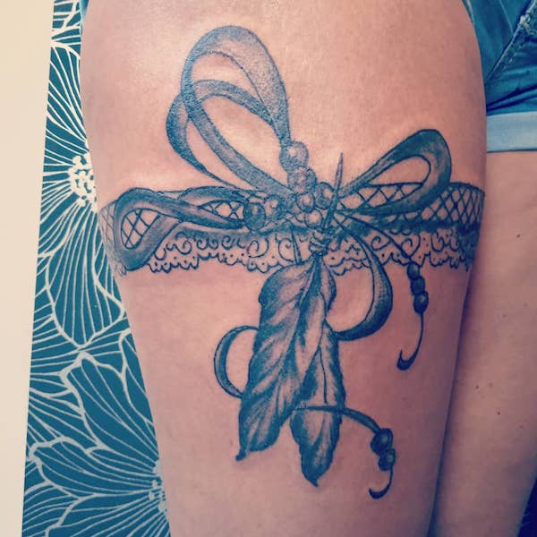 Lace garter with ribbon bow and feathers