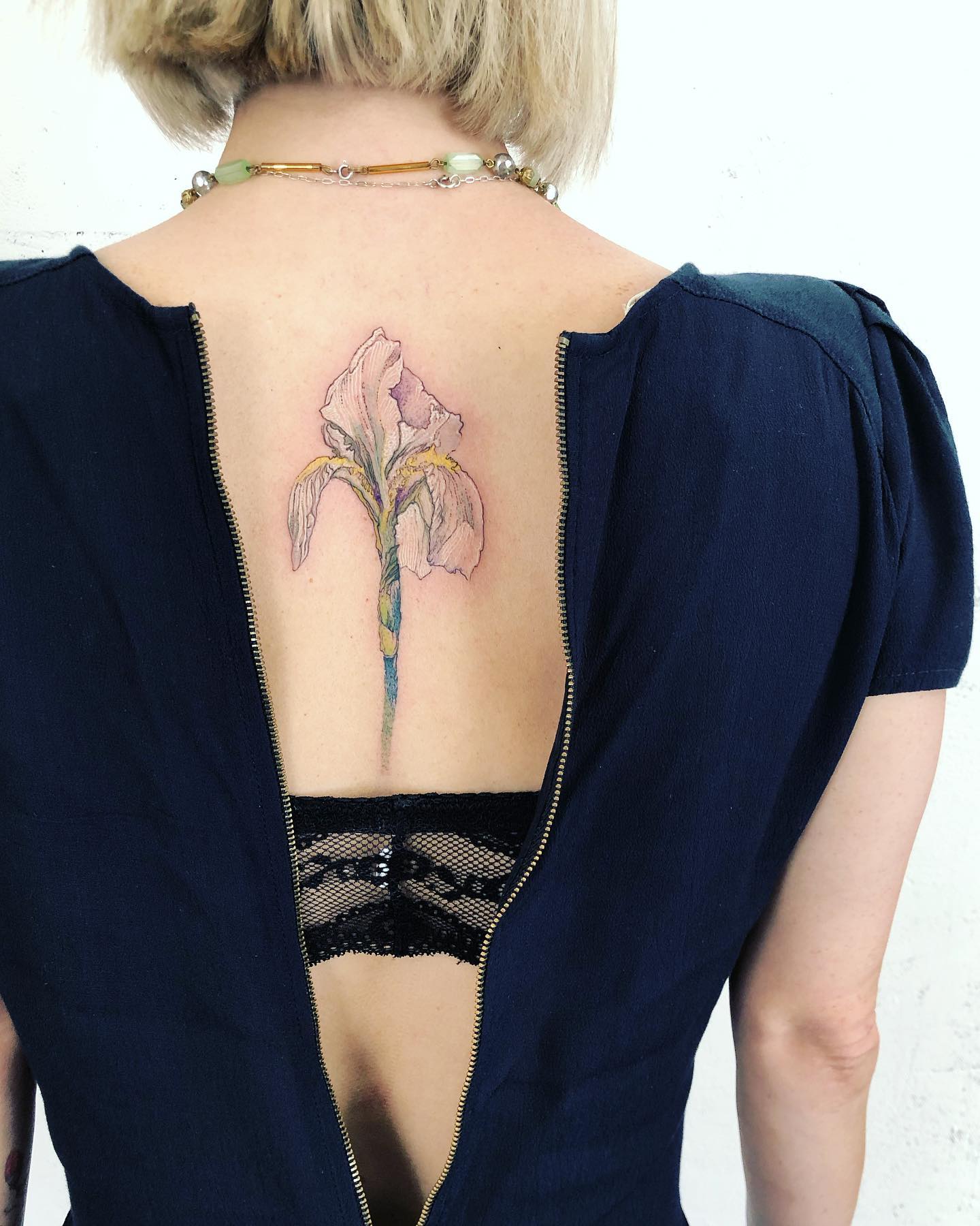 Light purple iris spine tattoo