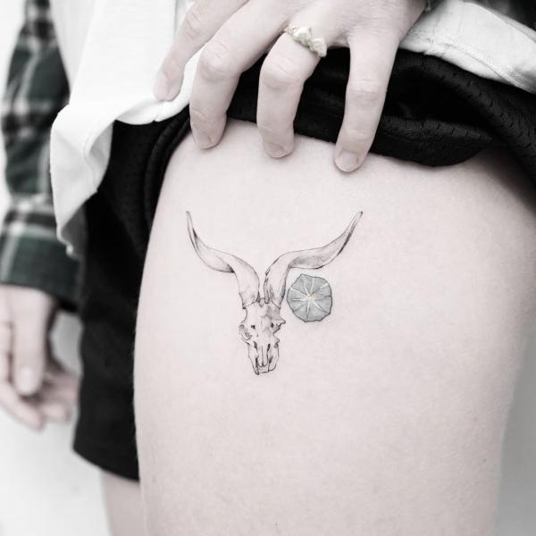 Minimalist goat skull thigh tattoo