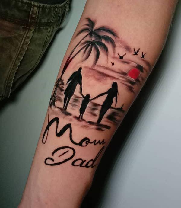 Mom and dad holding hands of child beside palm trees on beach