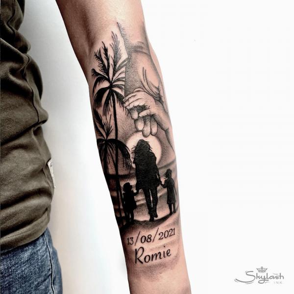 Mom holding hands of two children walking at beach