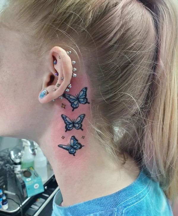 Small butterfly neck tattoo blue