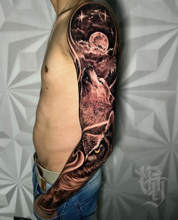 Realistic full sleeve tattoo with a wolf howling at the moon