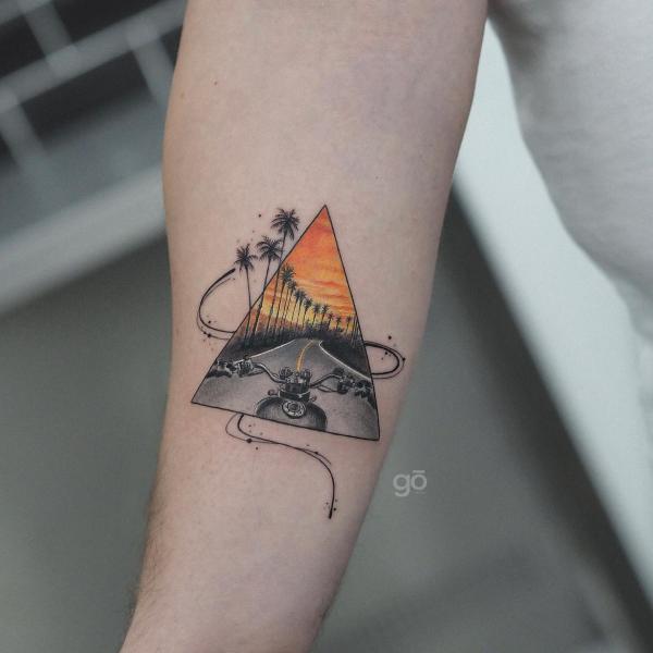 Riding a motorbike on a road lined with palm trees