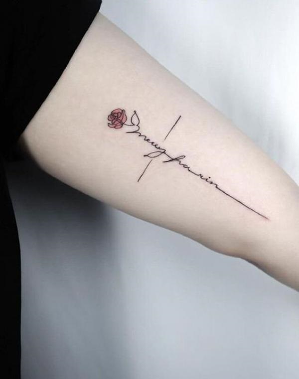 Rose with cross inscribed in cursive and plain line