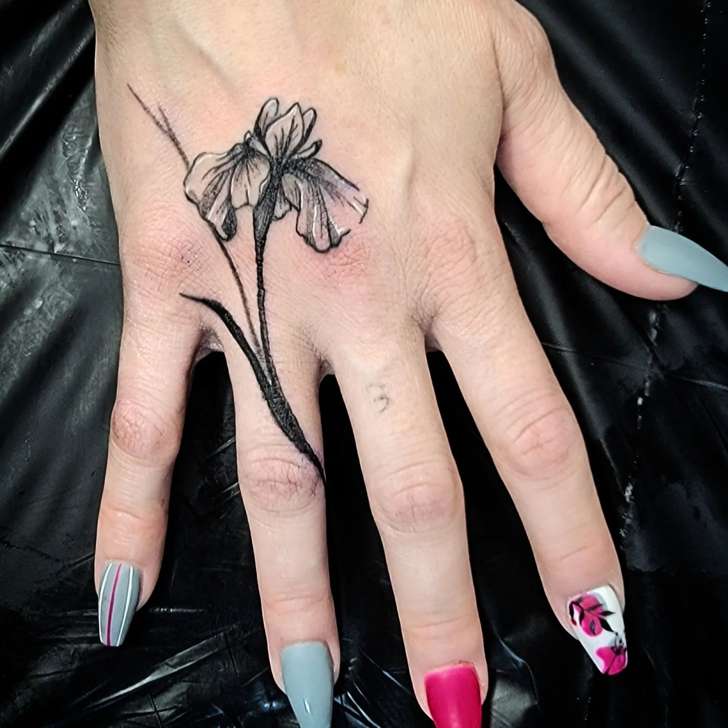 Simple iris hand tattoo