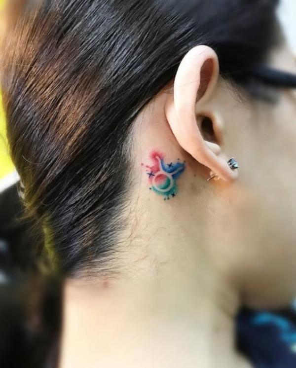 Simple watercolor Taurus Glyph ear tattoo