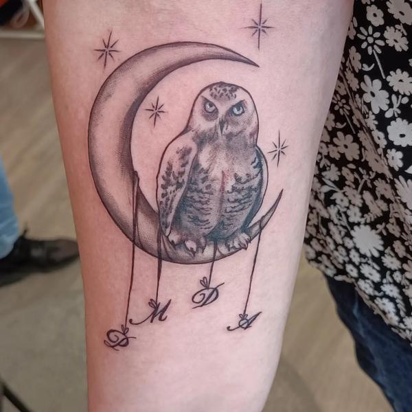 Sketchy owl sitting on crescent moon tattoo with stars