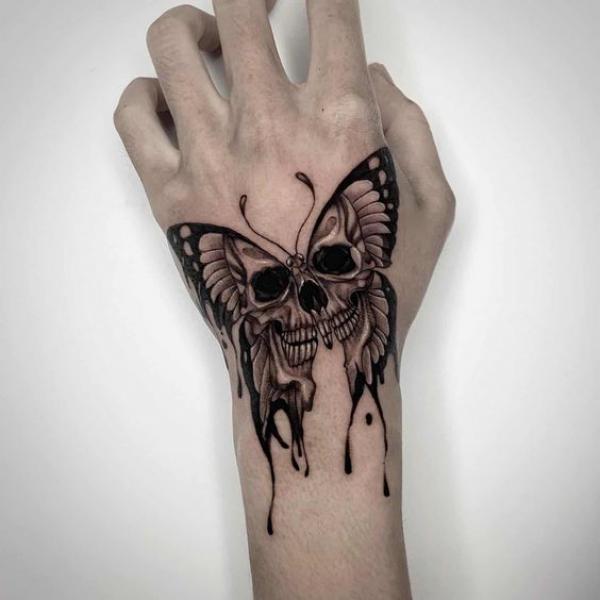 Butterfly skull tattoo hand