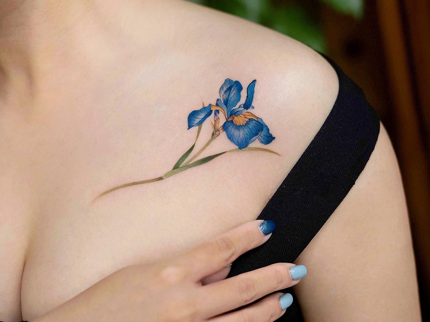 Small iris clavicle tattoo