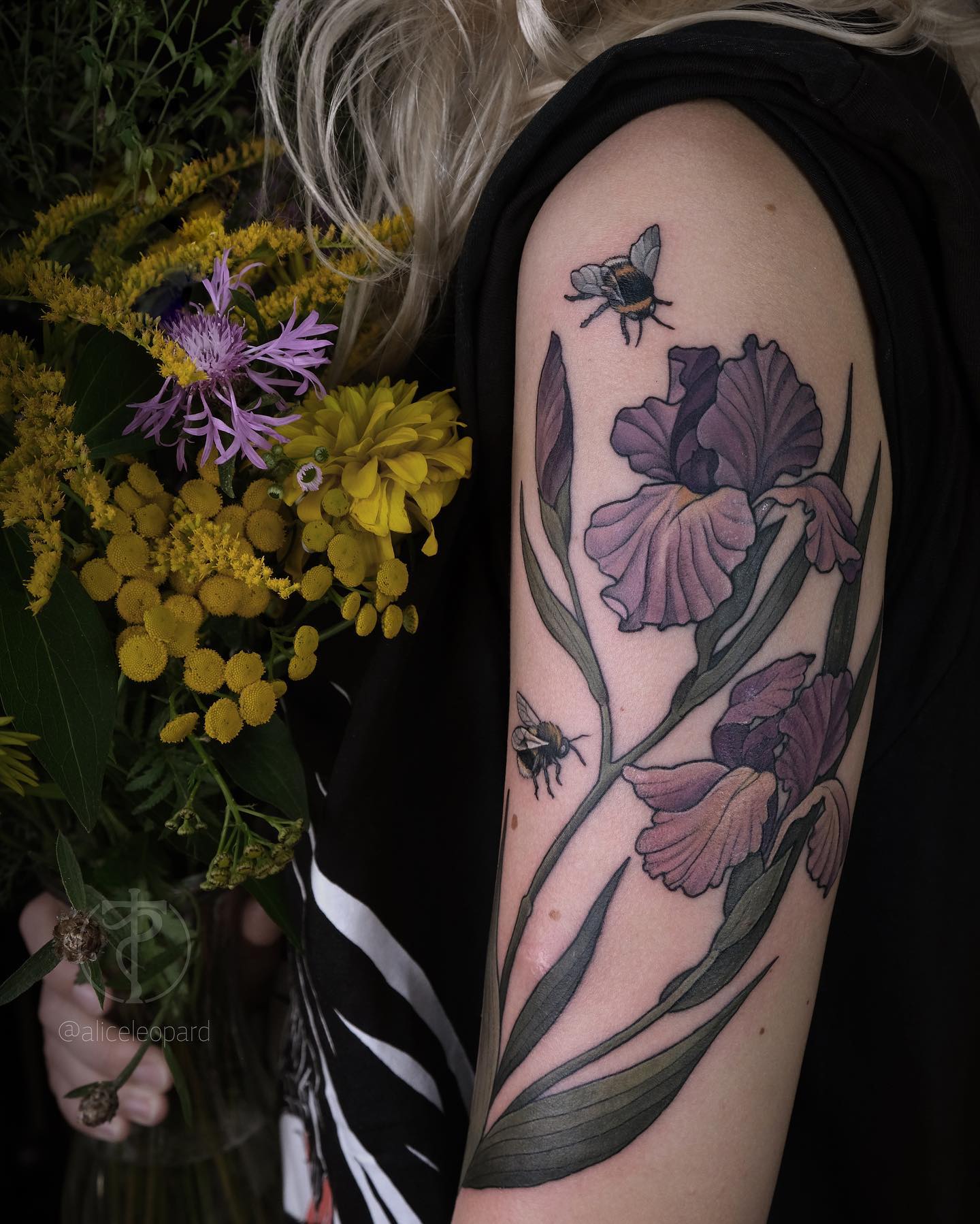 Two bees flying over iris