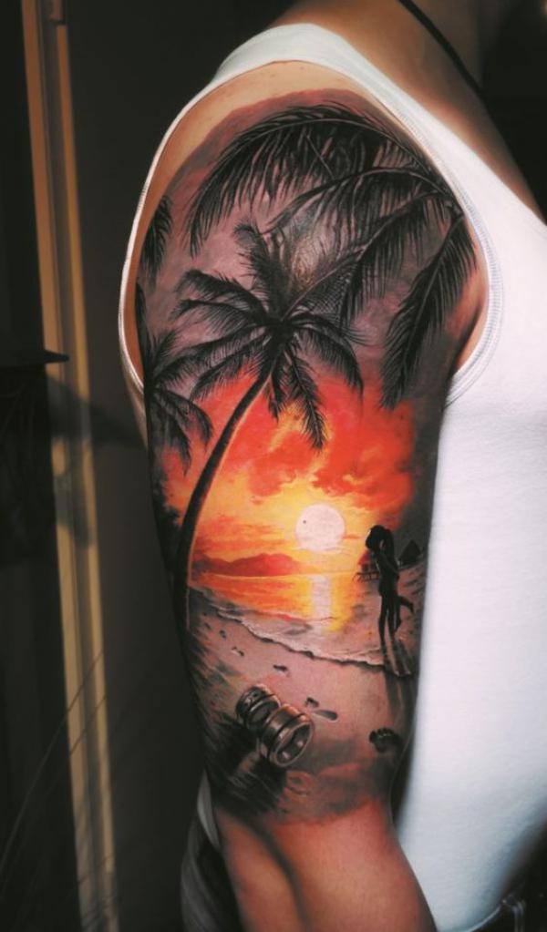 Two lovers hugging under a palm tree at sunset