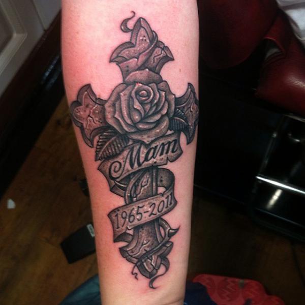 Vintage cross wrapped with rose and ribbon with the word Mam and years