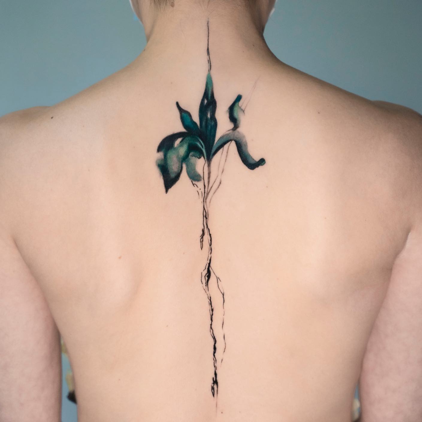 Watercolor iris spine tattoo