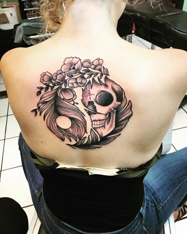 Yin yang symbol with flowers and skull