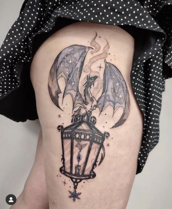 A bat sitting on a lamp