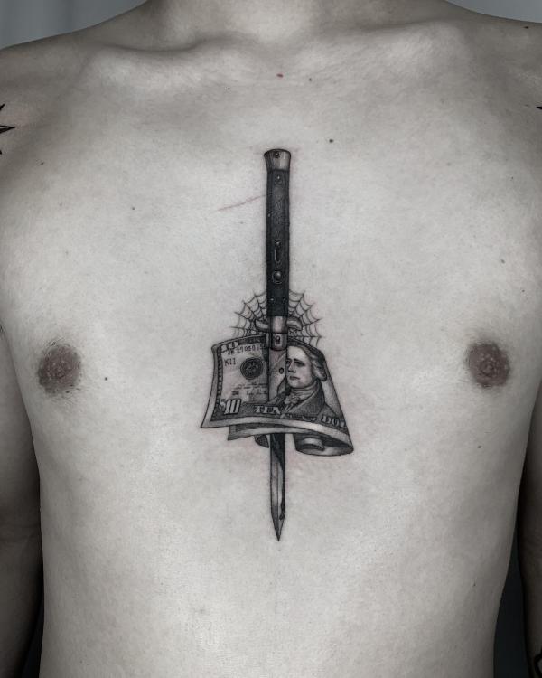 A dagger through spider web and money