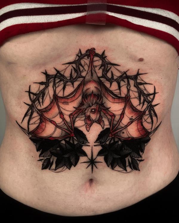 Bat underboob tattoo with thorns
